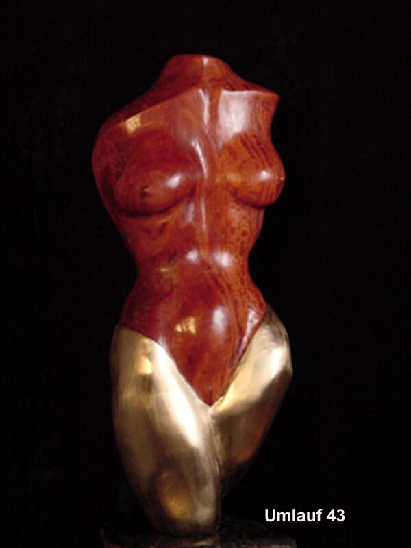 A red and gold statue of a woman 's torso.