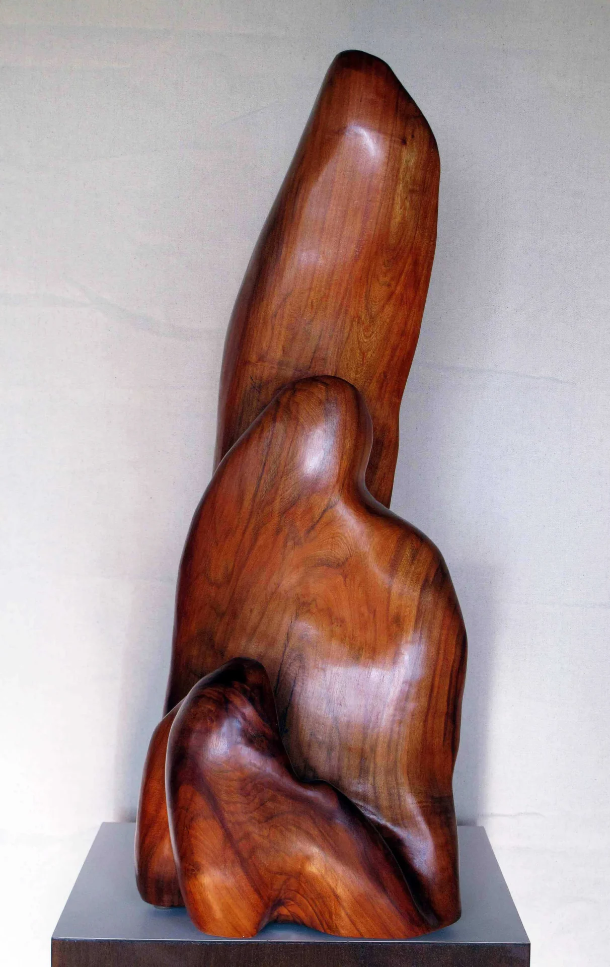 A wooden sculpture of a person 's head and arm.