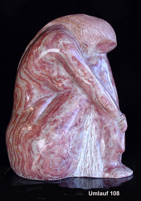 A pink and white marble statue of a monkey.