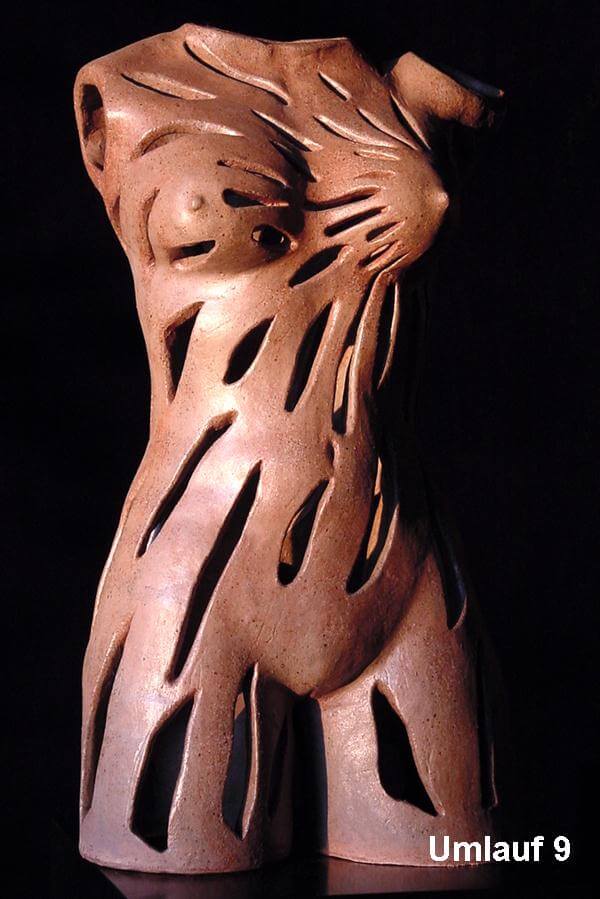 A sculpture of a woman 's torso with a zebra pattern.