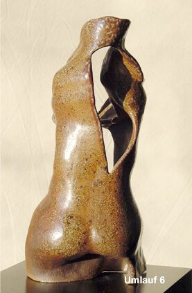 A brown vase with some brown paint on it