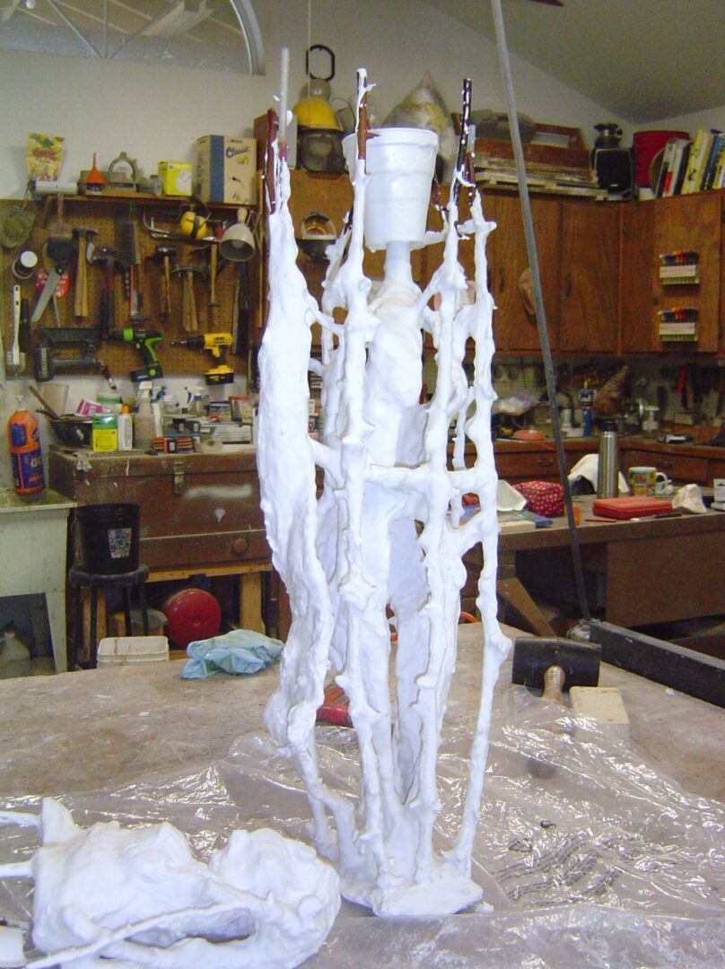 A white sculpture is being made in the workshop.