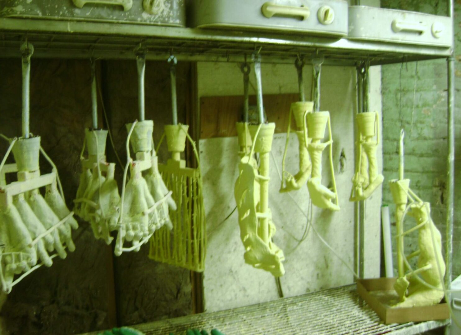 A kitchen with many hanging clothes on the wall