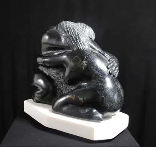 A sculpture of two animals sitting on top of each other.