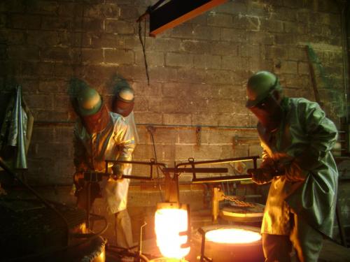 A group of people working in a foundry.