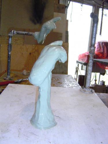 A white statue sitting on top of a table.