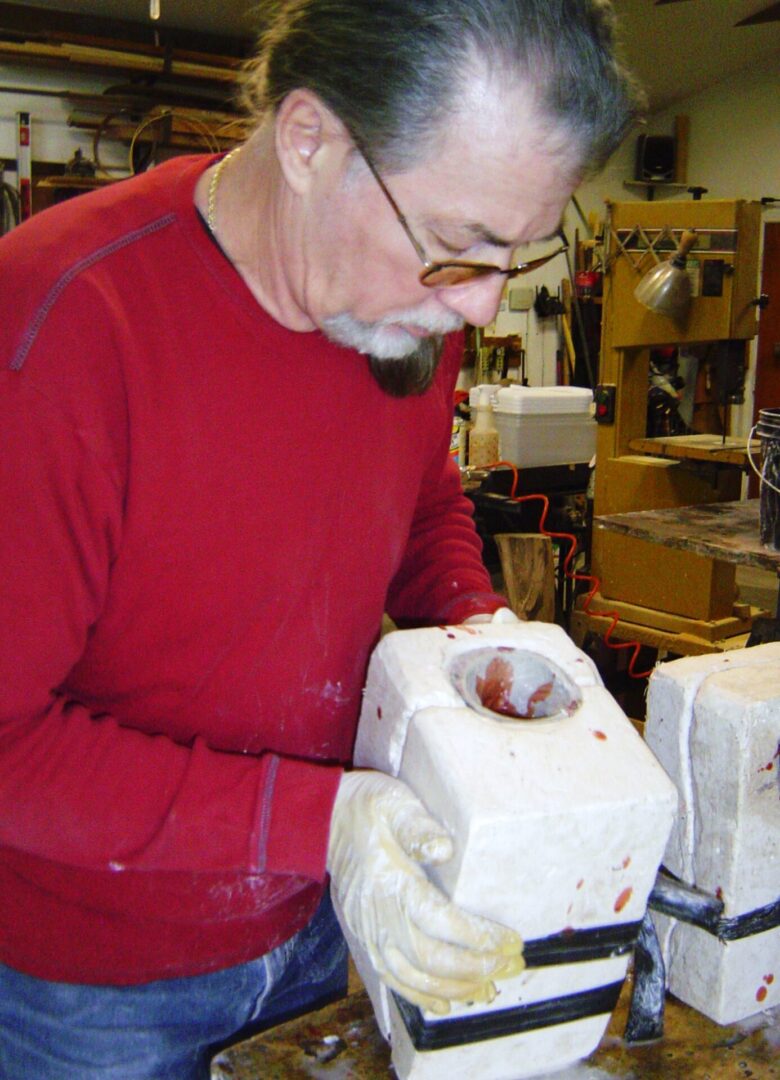 A man wearing a red shirt making a Mother Mold.