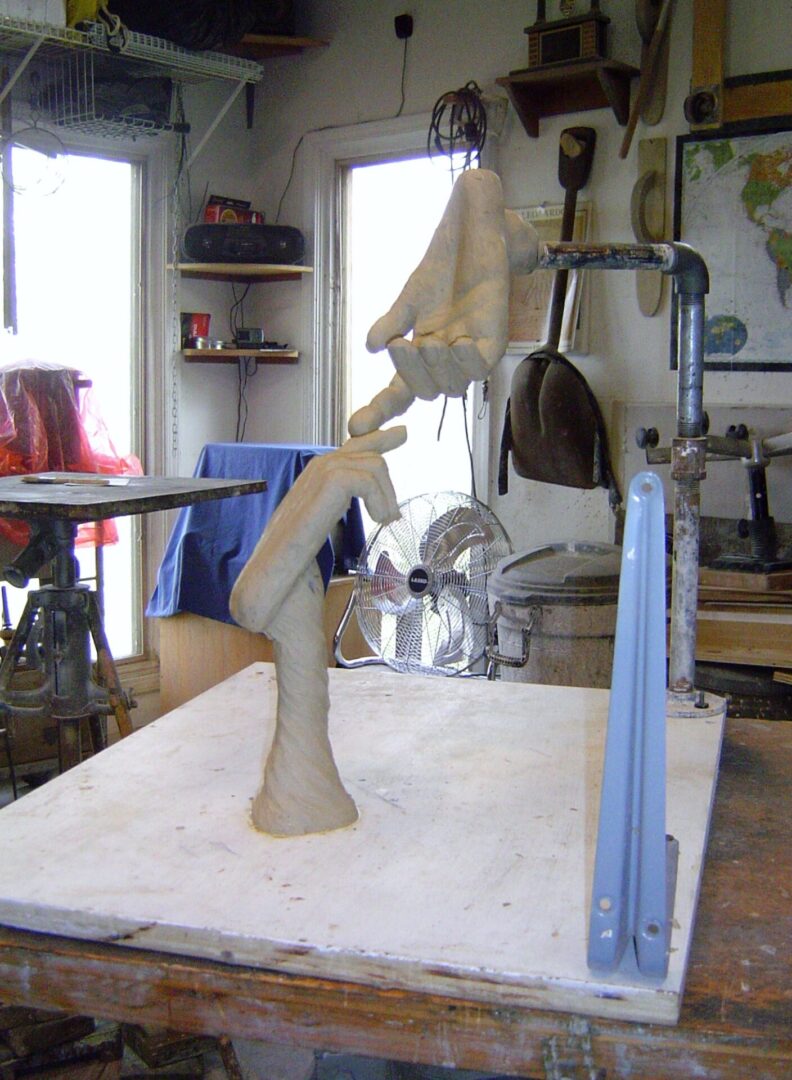 A wooden table in a workshop being used for making a Mother Mold.