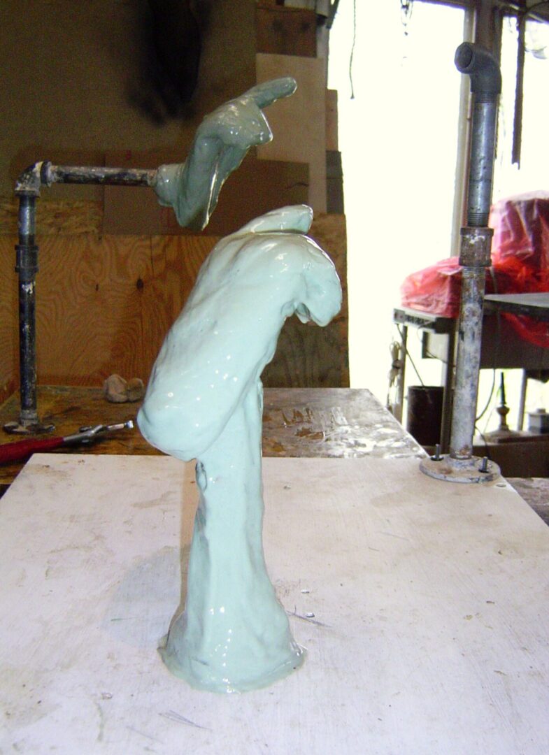 Creating a Mother Mold for a sculpture of a hand on a table.