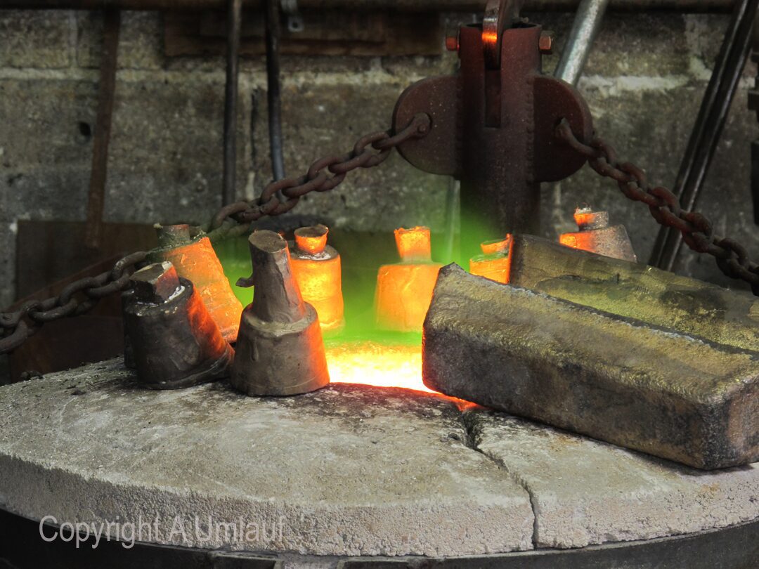 In a blacksmith shop, a skilled blacksmith is crafting a piece of metal.