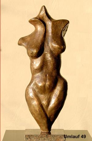 A bronze sculpture of a woman displayed in a Fine Art Gallery.