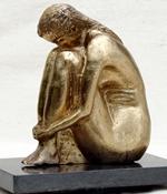 A bronze sculpture of a woman sitting on a marble base displayed in a Fine Art Gallery.