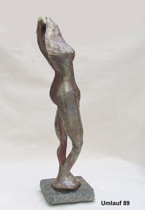 A bronze sculpture of a woman on display in a Fine Art Gallery.