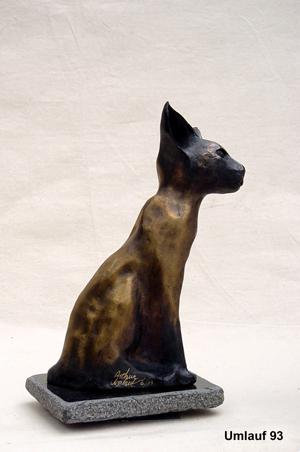 A bronze statue of an Egyptian cat displayed in a Fine Art Gallery.