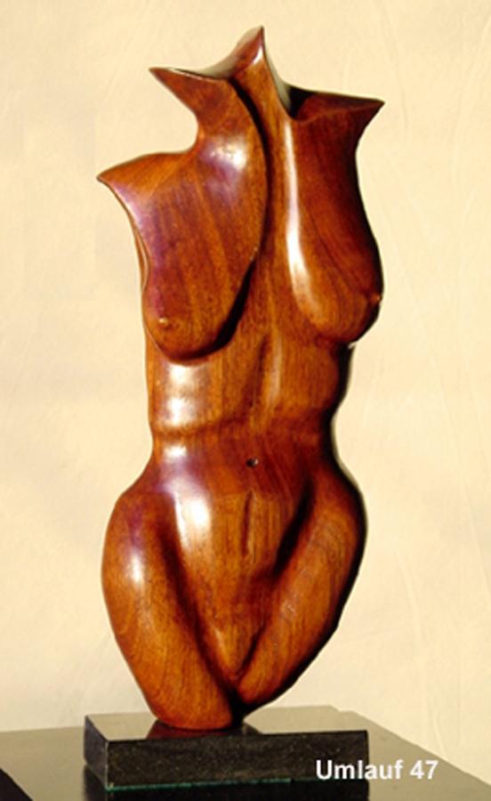 A wooden sculpture of a woman on a stand, part of a Sculpture Collection.