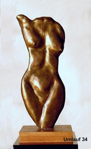 A bronze sculpture of a woman displayed in a Fine Art Gallery.