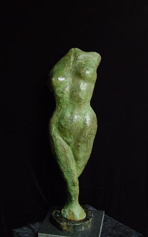 A green sculpture of a woman showcased in a fine art gallery.