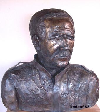 A bronze bust of a man with a moustache displayed in a Fine Art Gallery.